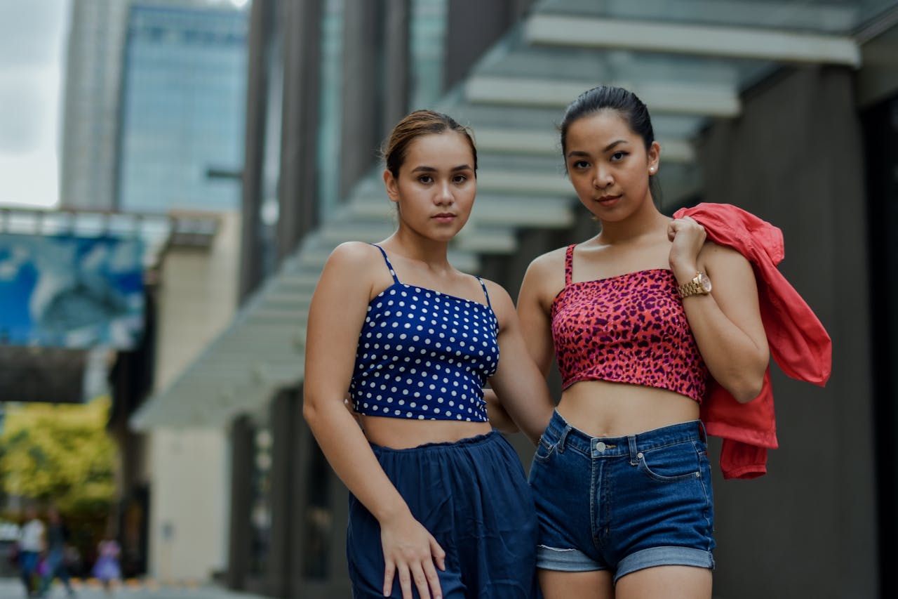 Stylish women posing in the city wearing casual summer outfits.